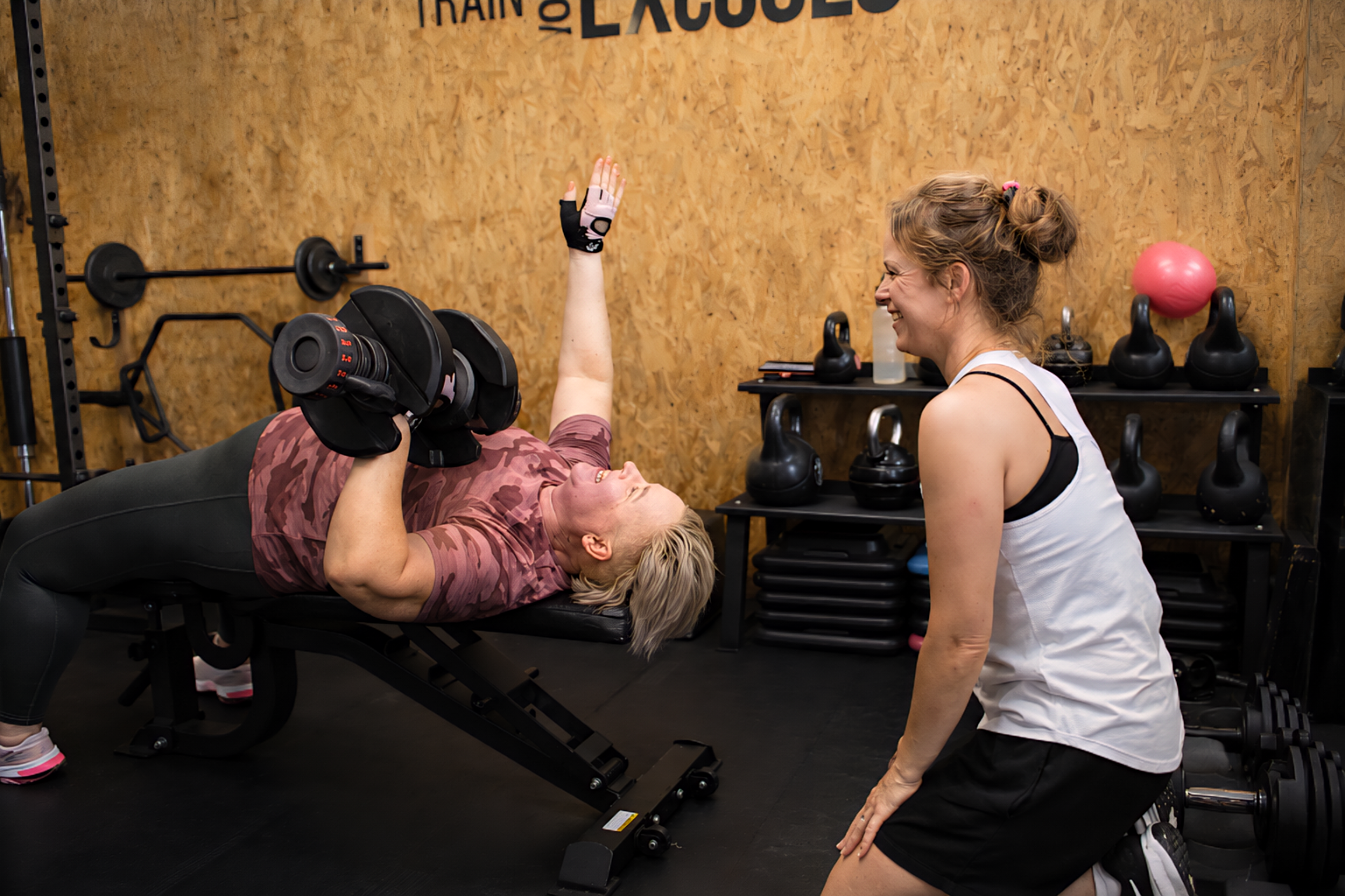 Esther coaching a client through an incline dumbbell press in her private Worthing studio
