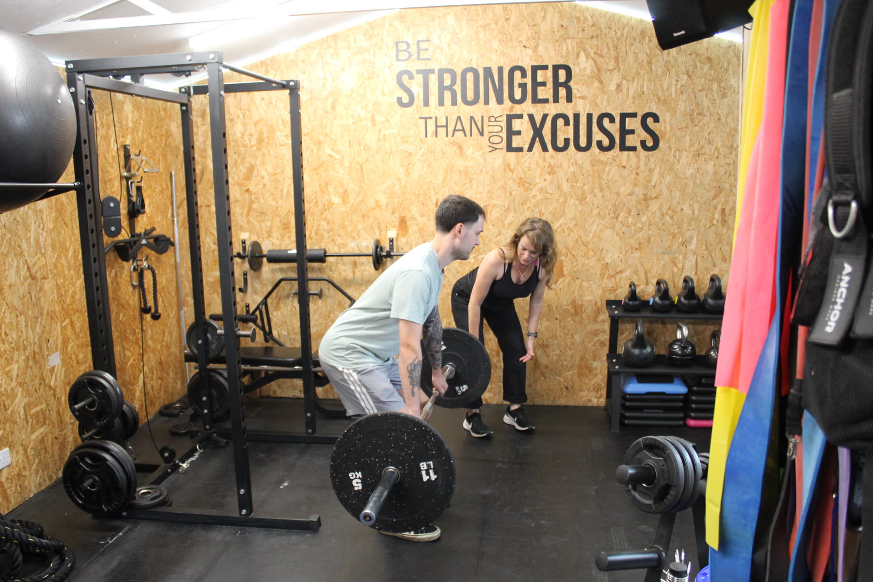 Esther coaching a client through a deadlift setup
