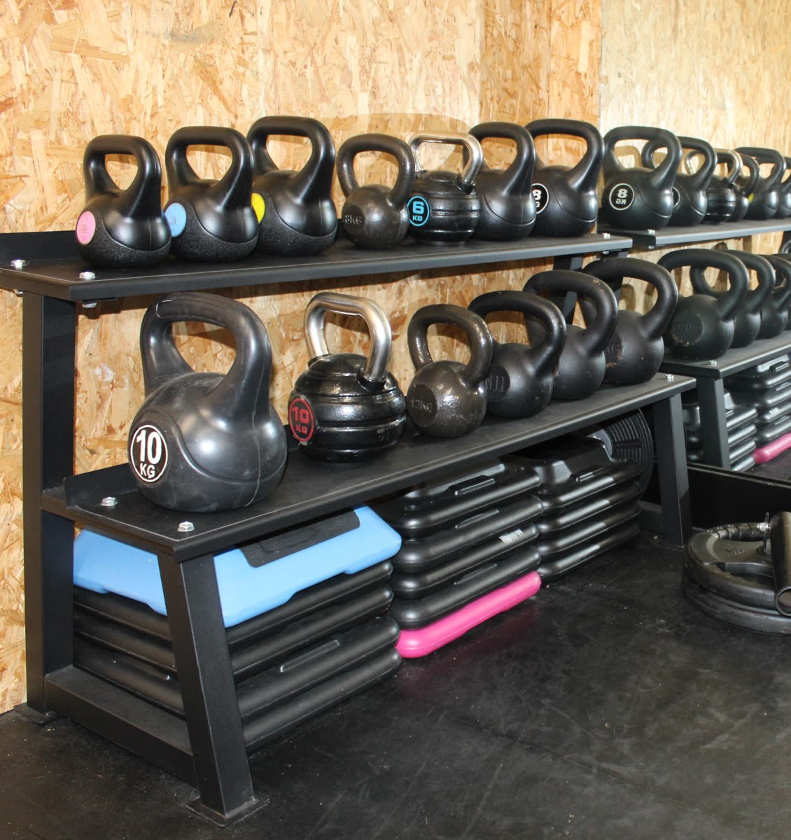 Kettlebells racked on the shelf in the Eternal Fitness studio